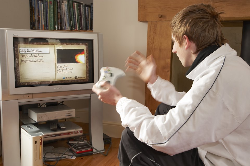 15 year old boy playing computer game. UK. April 2007.